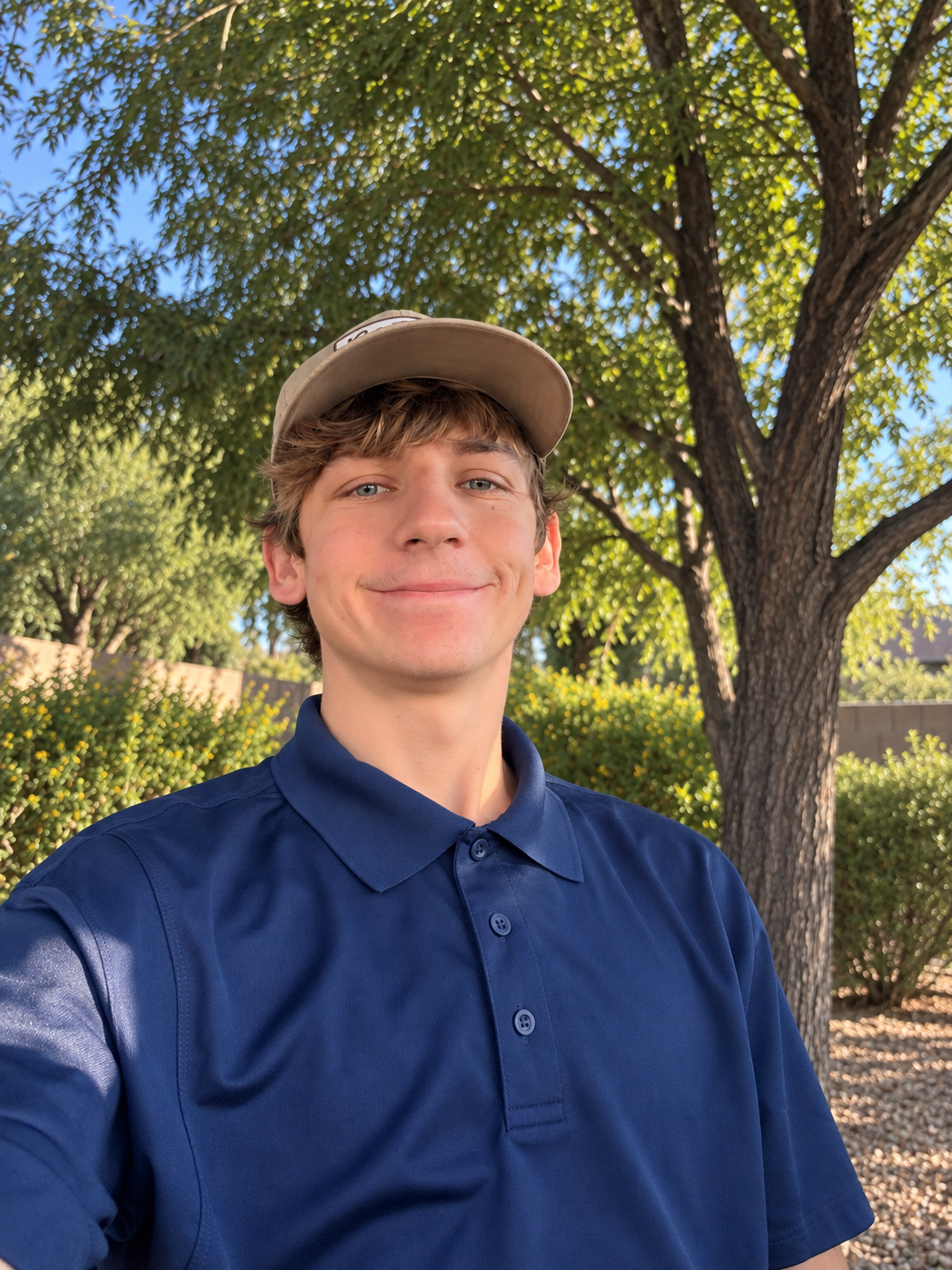 Anthony Newlin outdoors in front of trees
